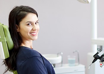 Woman smiling sitting in a dental chair