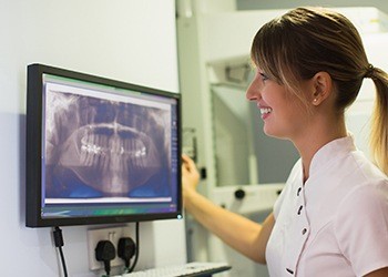 Dental assistant looking at x-rays
