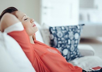 Relaxing woman with hands behind head