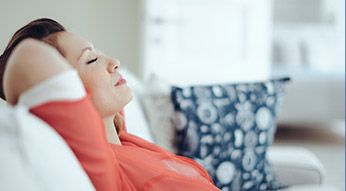 Relaxing woman with hands behind head