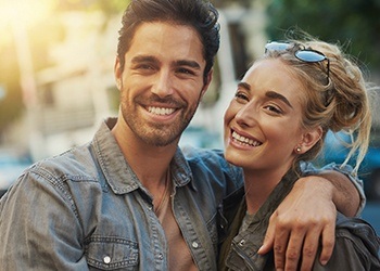 Smiling man and woman outdoors