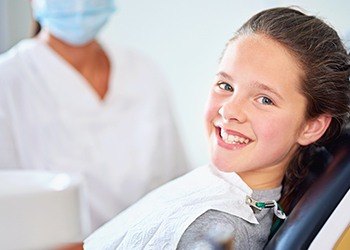 Young woman smiling in dental chair