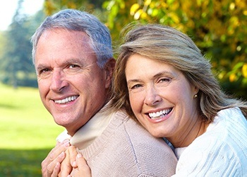 Smiling older man and woman outdoors